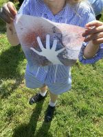 Child making a stone age hand print