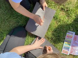 Child making a stone age hand print