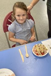 Child with a pasta salad.