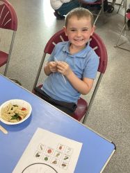 Child with a pasta salad.