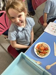Child with a pasta salad.