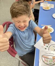 Child with a pasta salad.