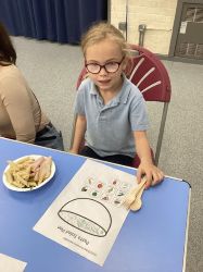 Child with a pasta salad.
