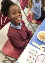 Child with a pasta salad.