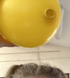 Static electricity from a balloon causing hair to stand up