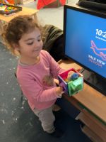 Child building a pig's house