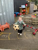 Child catching a large ball