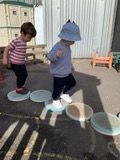 Child stepping along the musical stepping stones