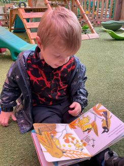Child reading in the nursery
