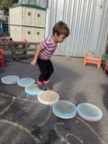 Child stepping along the musical stepping stones
