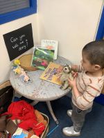 Child building a pig's house
